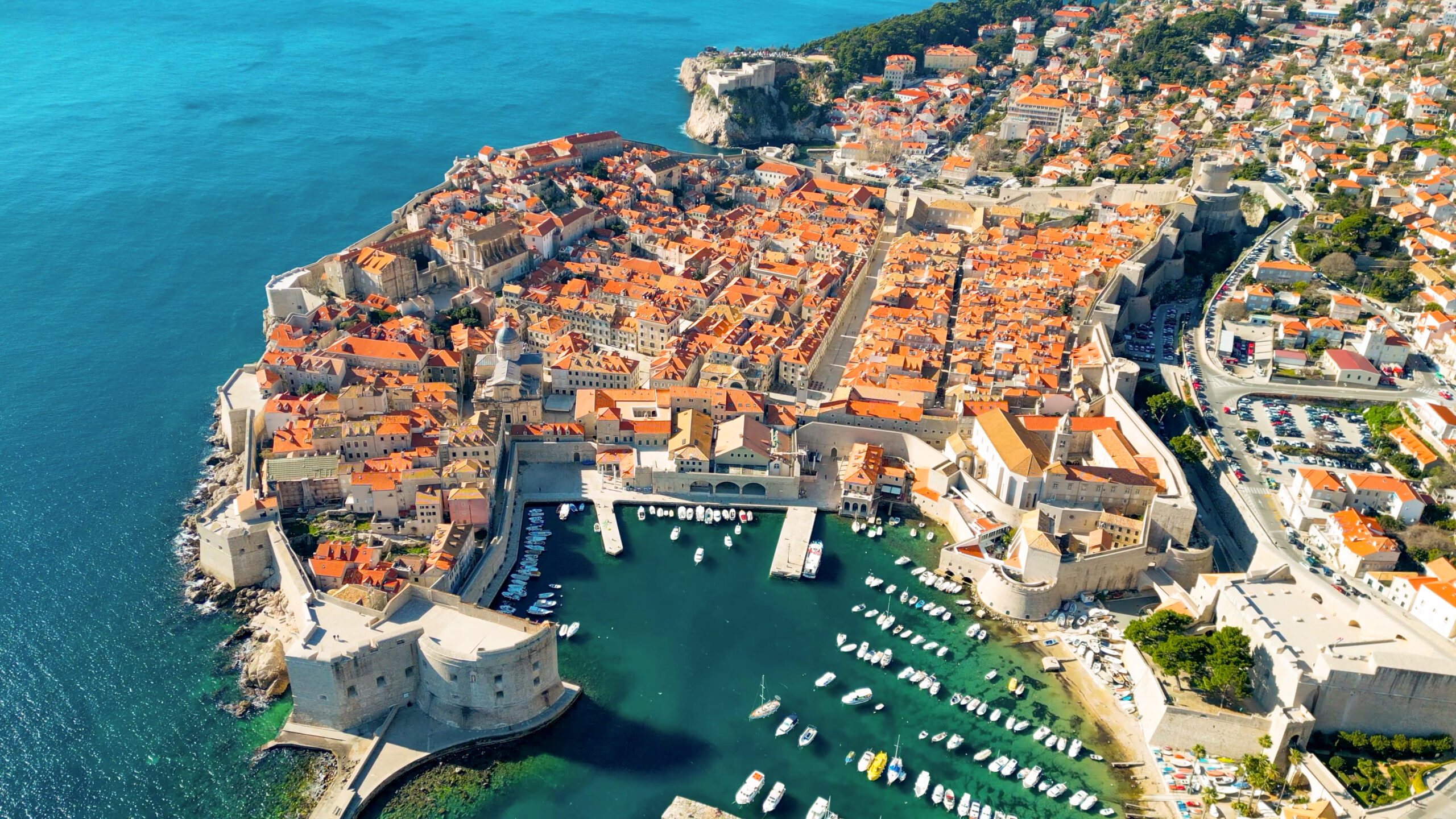 Aerial view of Dubrovnik’s walled Old Town and Adriatic Sea — terracotta roofs,Historic fortifications and harbor
