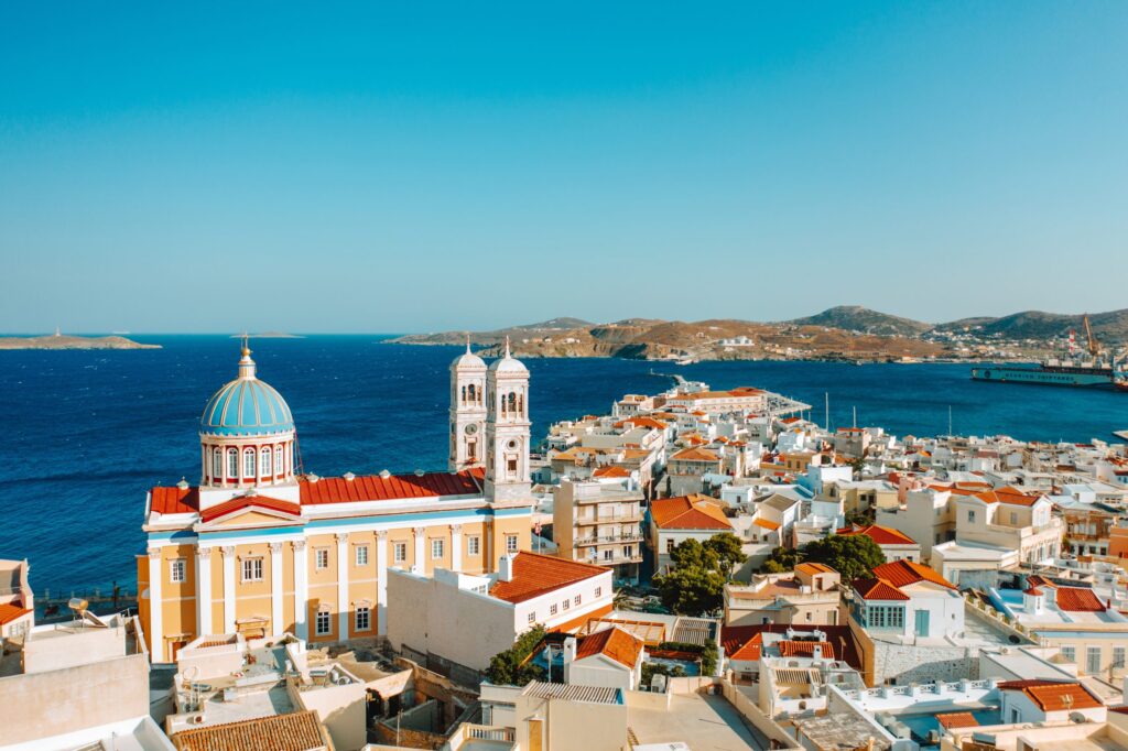 Saint,Nicolas,Cathedral,,Ermoupoli,,Syros,,Greece The blue-domed Church of Saint Nicholas overlooking the Aegean Sea, surrounded by the charming rooftops of Syros.