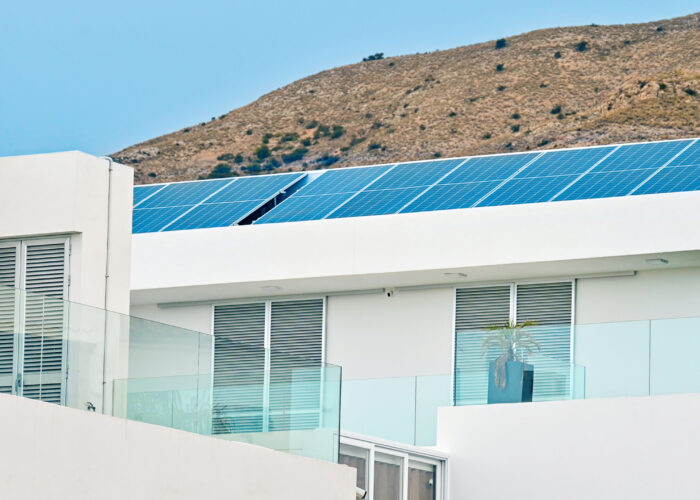 Solar panels on a building roof in Sierra Cortina, Spain