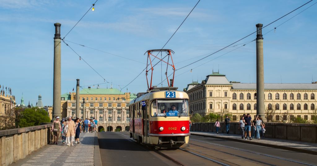 The tram 23 in Czechia prague and people walking by the bridge.