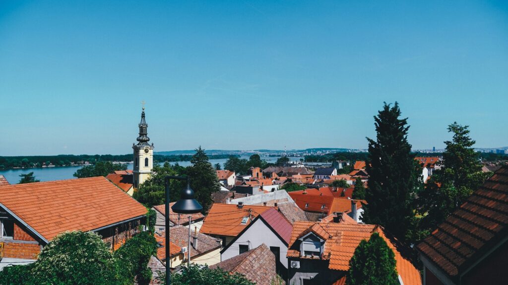 View over Zemun’s red rooftops, church tower, and the Danube River in Belgrade, Serbia.