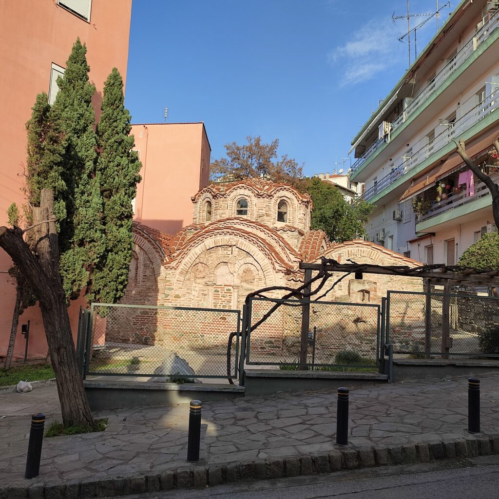 Byzantine Bath. ©ThanasisKoukopoulos_(1) Byzantine Bath in Ano Poli, Thessaloniki, surrounded by residential buildings and cypress trees.