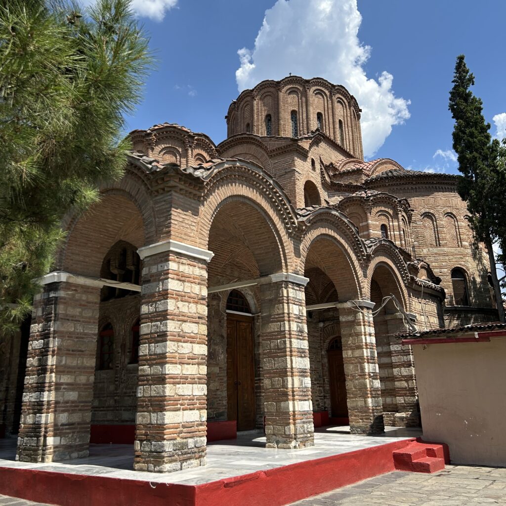 Church of Prophet Elijah. ©AlexandrosTsavdaroglou_ Church of Prophet Elijah in Thessaloniki, with brick arches, domes, and Byzantine architecture under a blue sky.