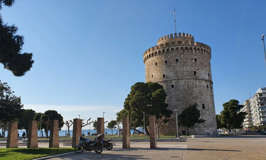 Byzantine Bath in Ano Poli, Thessaloniki, surrounded by residential buildings and cypress trees.